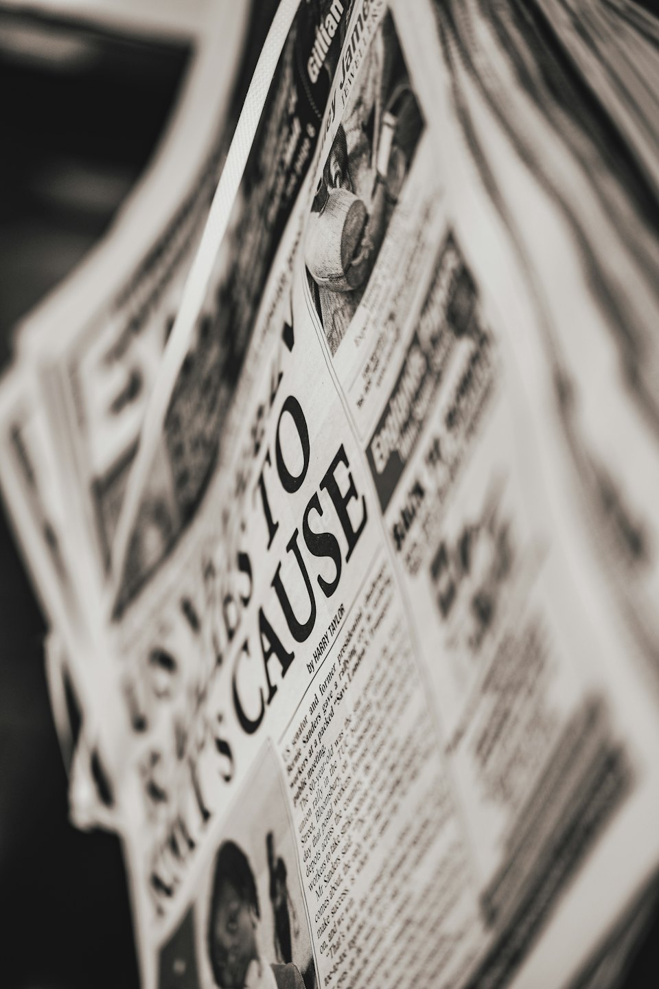 Stacked newspapers featuring the headline Loves to Cause.